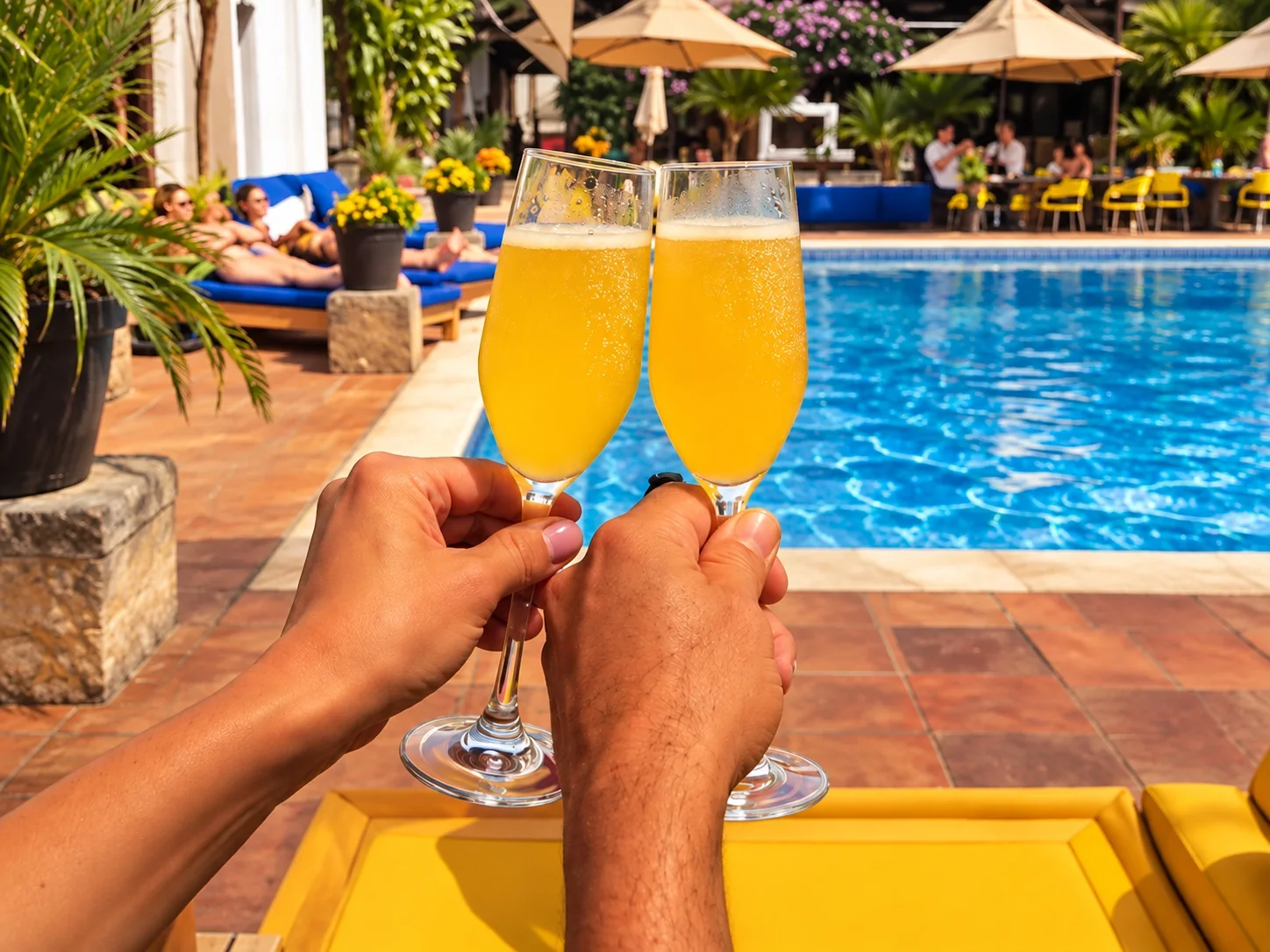Guests toasting with refreshing drinks beside the pool